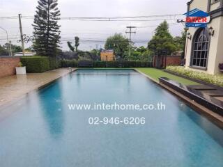 Backyard swimming pool with surrounding patio.