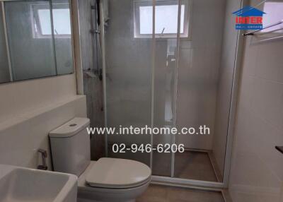 Modern bathroom with glass-enclosed shower and window