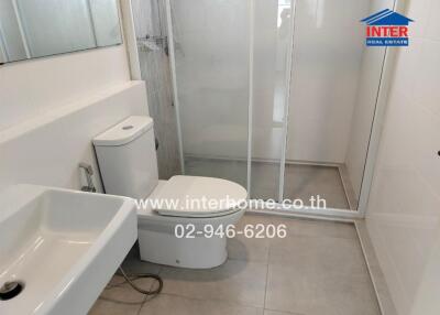 Modern bathroom with a shower enclosure, toilet, and sink