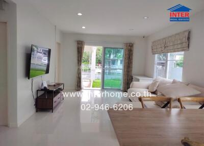 Living room with modern furnishings and large windows