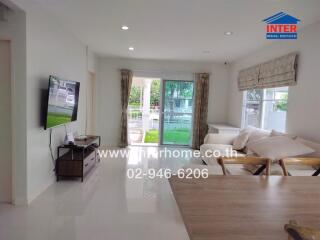 Living room with modern furnishings and large windows