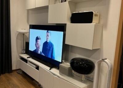 Modern living room with entertainment system and wall-mounted cabinets