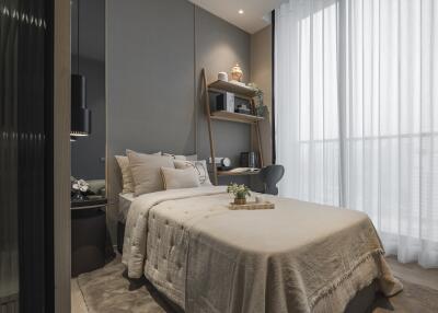 Modern bedroom with a cozy bed, decor items, and large windows with sheer curtains