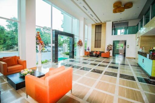 Spacious and modern lobby area with large windows and elegant decor