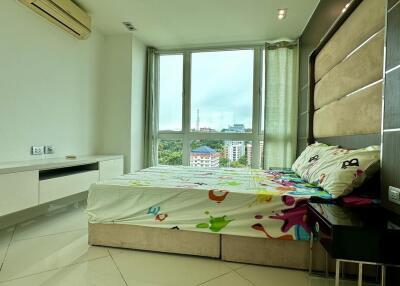 Modern bedroom with large window and city view