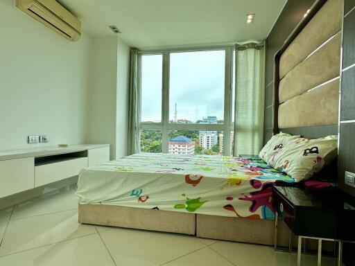 Modern bedroom with large window and city view