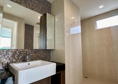 Modern bathroom with large sink and glass shower