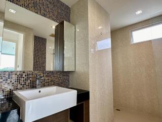 Modern bathroom with large sink and glass shower