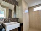 Modern bathroom with large sink and glass shower