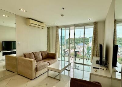 Modern living room with sofa, TV, and balcony view