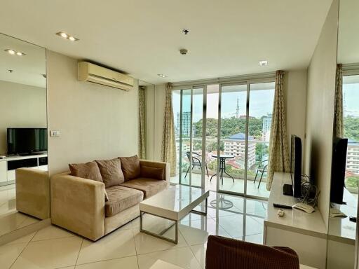 Modern living room with sofa, TV, and balcony view