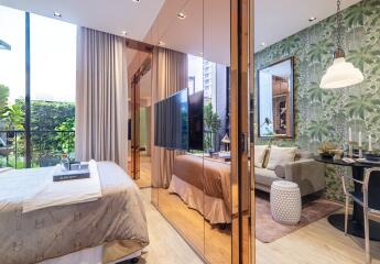 Modern bedroom with large windows, mirrored closet, and a view of a scenic garden