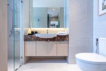 Modern bathroom with glass walk-in shower and sleek fixtures