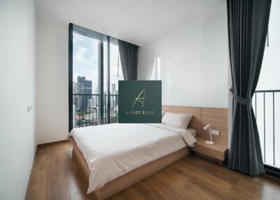 Bedroom with large windows and city view