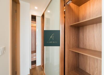 Walk-in closet with wooden shelves and sliding doors