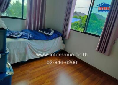 Bedroom with windows and wooden floor