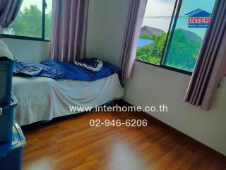 Bedroom with windows and wooden floor