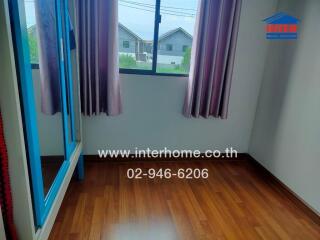 Modern bedroom with hardwood floor and large window