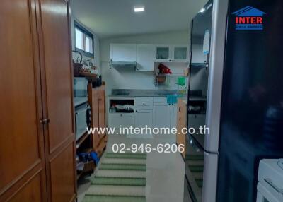 A cozy kitchen featuring wooden cabinets, modern appliances, and ample countertop space.