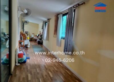 Hallway with wooden floors and windows