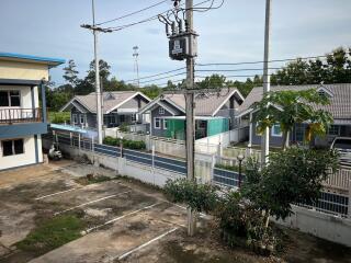 View of residential buildings with adjacent parking area