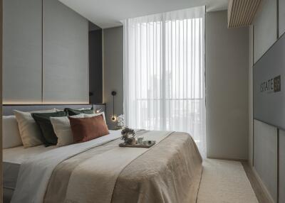 Modern bedroom with a large bed, neutral colors, and large window with sheer curtains.