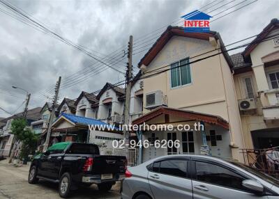 Row of residential houses with parked cars