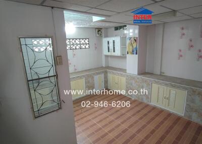 Kitchen area with unique tiled flooring and built-in cabinetry