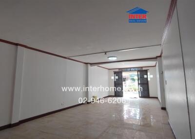 Spacious main living area with tiled flooring and natural light