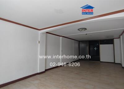 Spacious living area with tiled floors and recessed ceiling