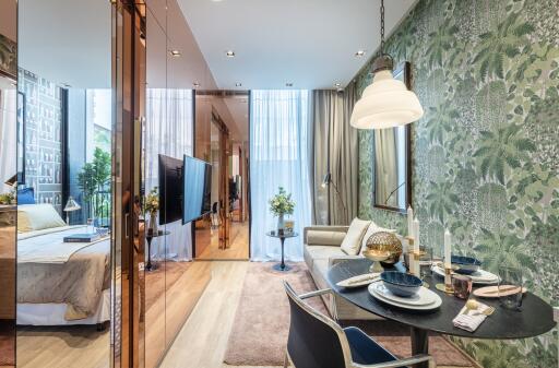 living area with dining table, sofa, and view into the bedroom