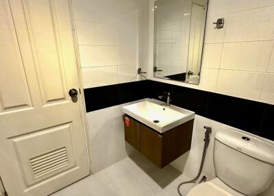 Modern bathroom with white tiles and fixtures