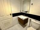 Modern bathroom with white tiles and fixtures