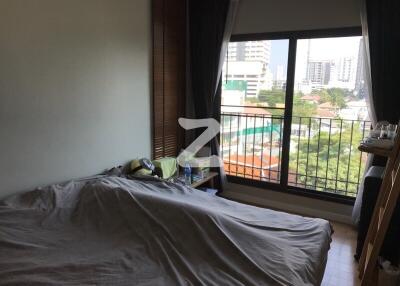 Spacious bedroom with large window and city view