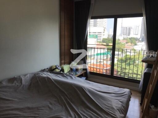 Spacious bedroom with large window and city view