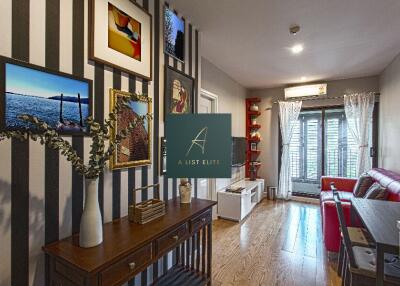 Contemporary living room with wall art and striped wallpaper