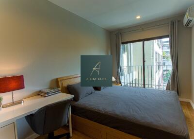 Spacious bedroom with desk and large window