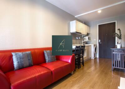 Modern living room with red sofa and kitchen area