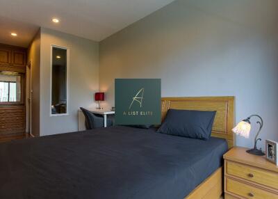 Modern bedroom with wooden furniture and desk