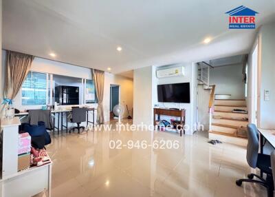 Spacious main living area with a dining table, air conditioning, and reflective tiled flooring