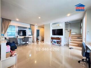 Spacious main living area with a dining table, air conditioning, and reflective tiled flooring