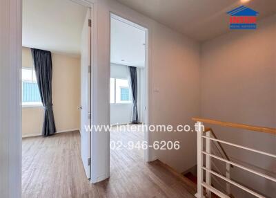 Bright hallway area with wooden floors and access to multiple rooms.