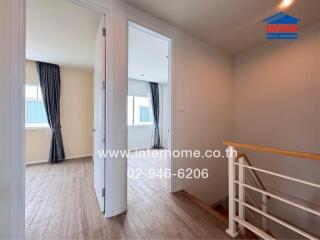 Bright hallway area with wooden floors and access to multiple rooms.