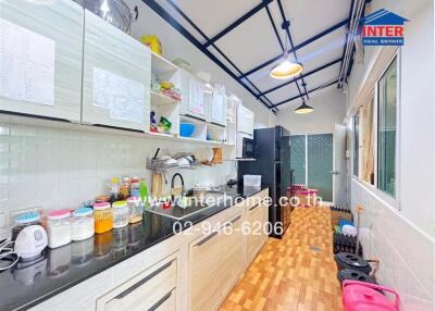 Modern kitchen with wooden flooring and ample storage