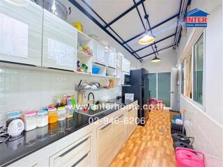 Modern kitchen with wooden flooring and ample storage