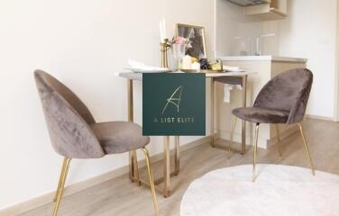 Modern kitchen dining area with velvet chairs and a small table