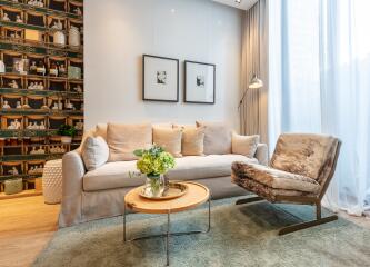 modern living room with beige sofa, fur chair, and decorated wall