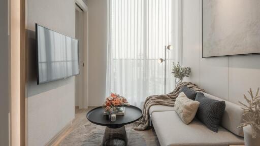 Modern living room with a wall-mounted TV and large window