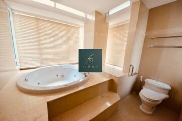 Bathroom with jacuzzi and toilet