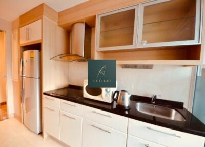 Modern kitchen with stainless steel appliances and wooden cabinets